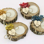 Wooden candle holders with heart tags for a forest wedding.