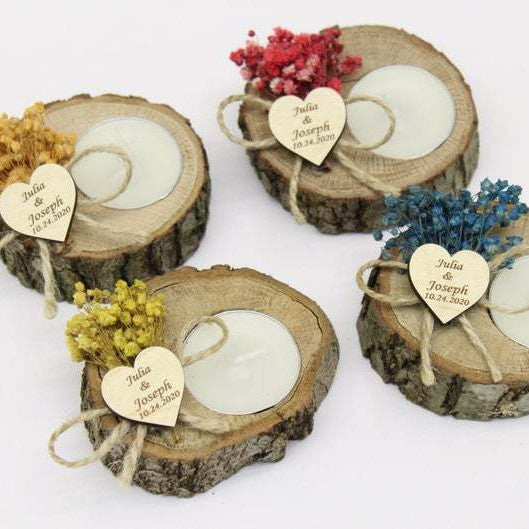Wooden candle holders with heart tags for a forest wedding.