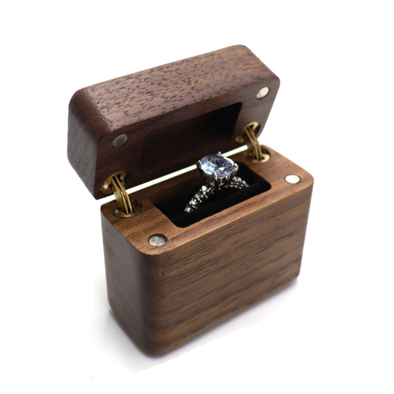 Mini walnut wood box with a ring inside.