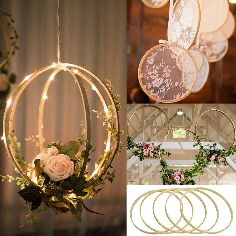 Gold hoops with floral arrangements for wedding decor.