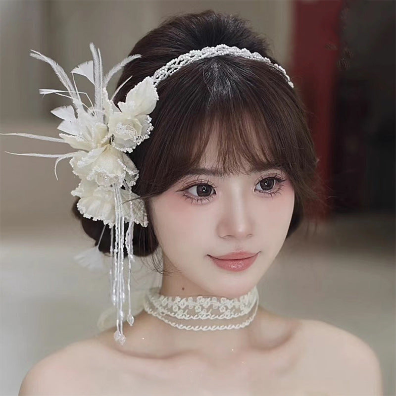 Woman with white floral bridal headpiece for wedding
